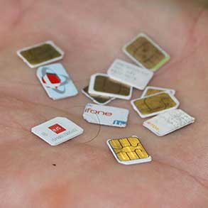 A dozen SIM cards in the palm of a hand